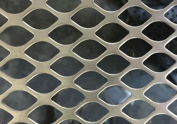 a piece of stainless steel perforated plate with diamond holes