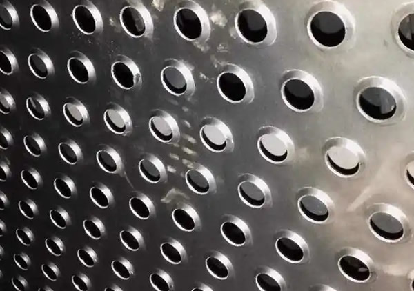 a piece of stainless steel perforated plate with embossed holes