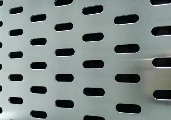 a piece of stainless steel perforated plate with end staggered slot holes