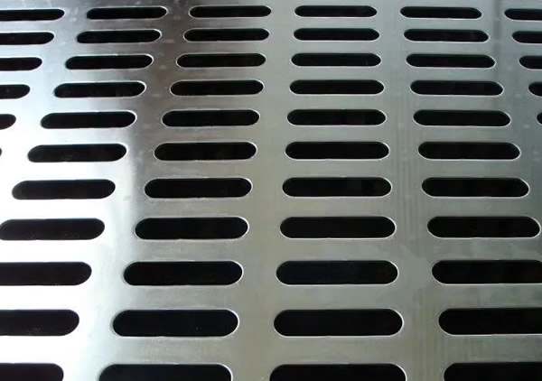 a piece of stainless steel perforated plate with straight slot holes