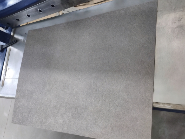 Freshly cut pure titanium sintered fiber felt sheet on a workshop cutting table