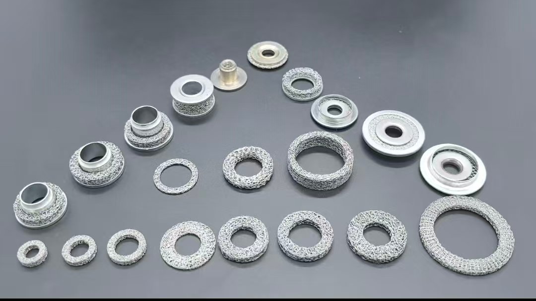 Custom Knitted Wire Mesh Rings and Composite Components A collection of compressed knitted wire mesh rings and metal composite components in different geometries