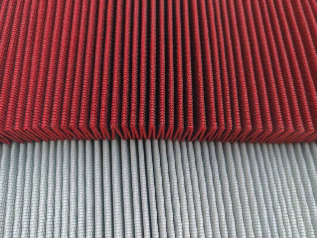 Pleated mesh support over red and light colored filter media