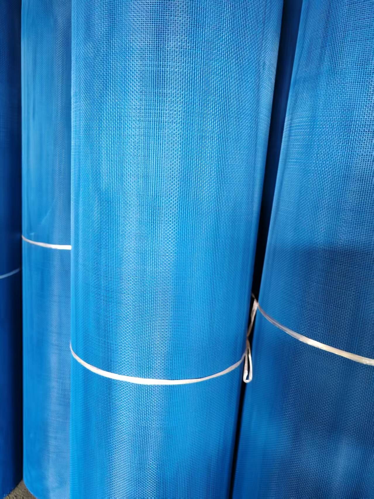 Blue coated wire mesh rolls with retaining straps