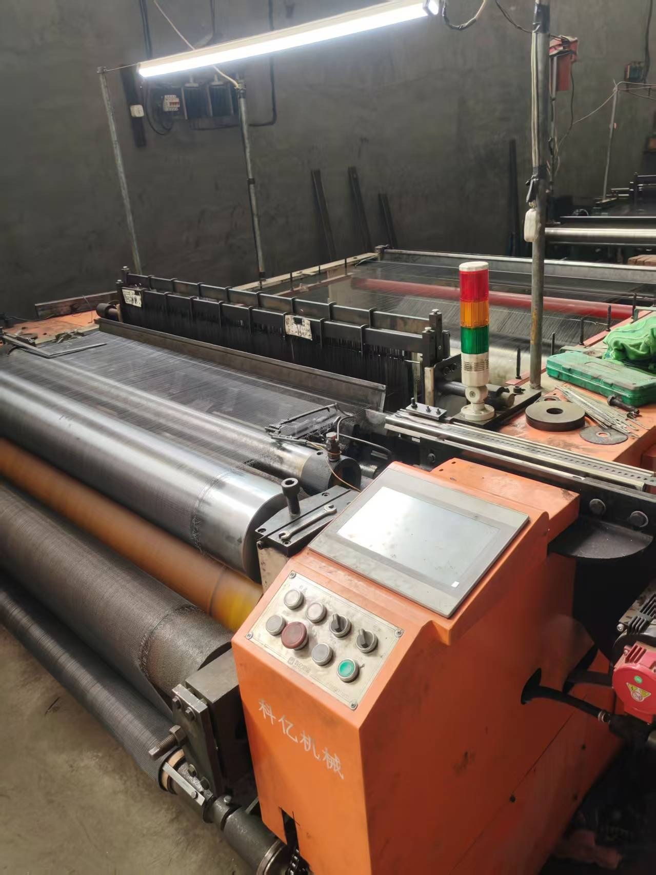 Wire mesh being woven on a loom before coating