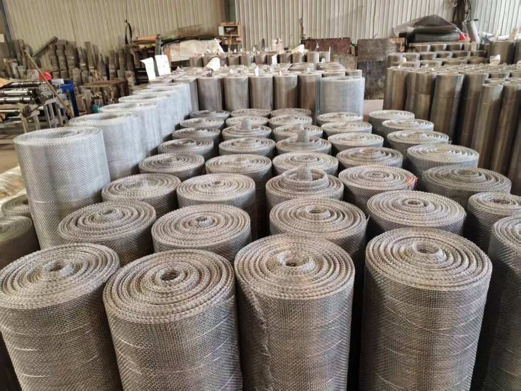 Rows of industrial woven wire mesh rolls in storage