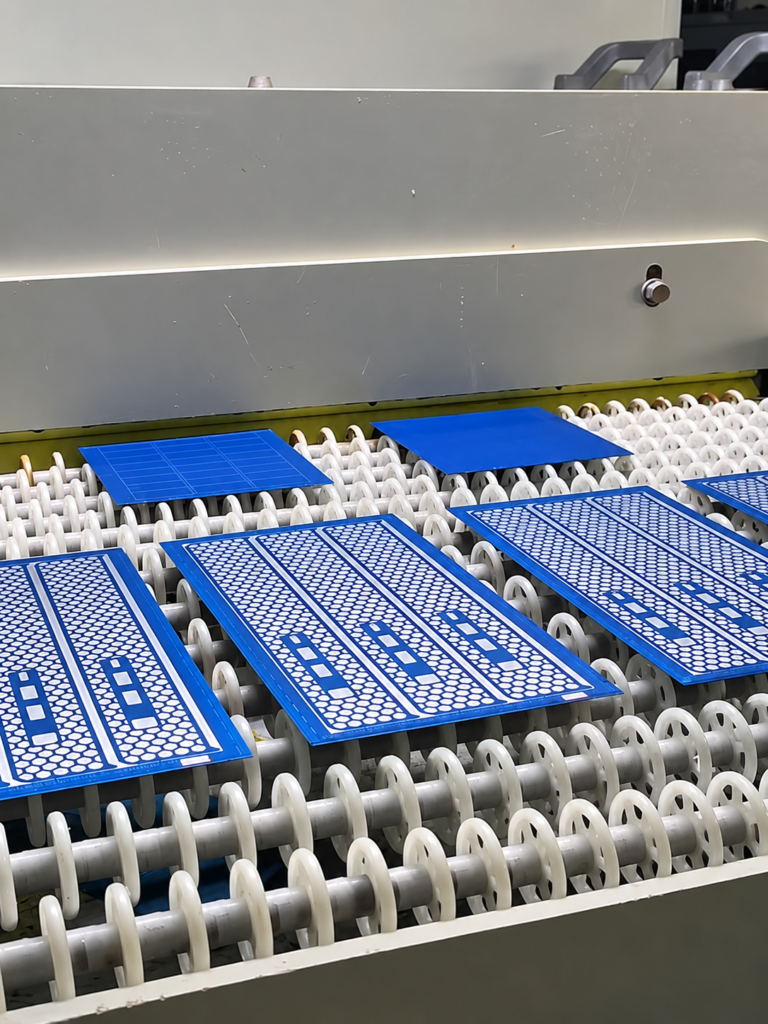Photoresist-coated patterned metal sheets on the roller feeding line