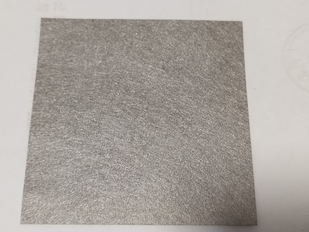 Rectangular sintered metal fiber felt sheet showing its fibrous surface and cut edges
