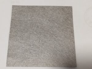 Rectangular sintered metal fiber felt sheet showing its fibrous surface and cut edges