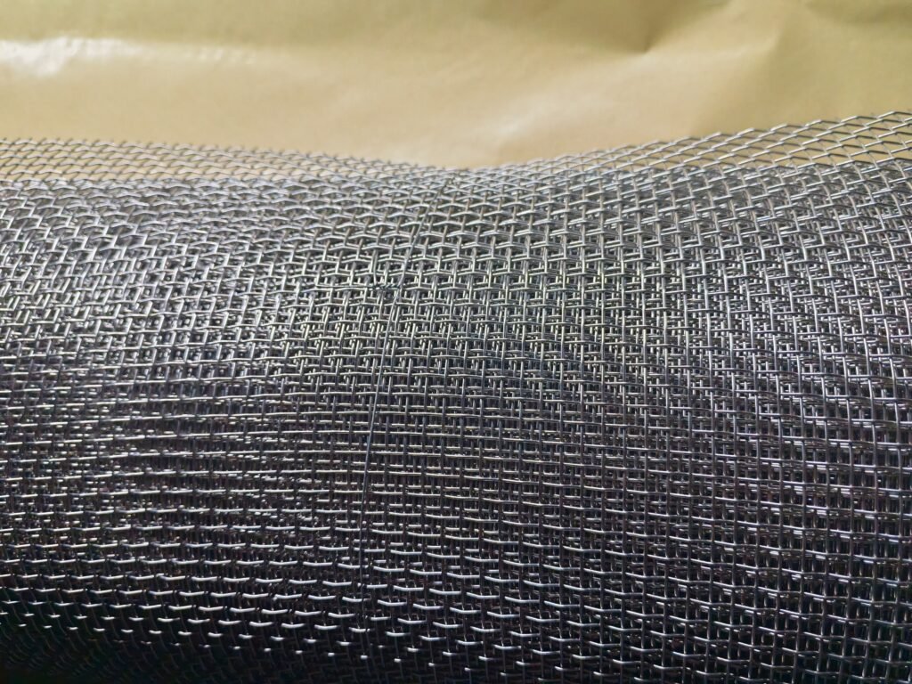 Real square woven wire mesh cloth showing intersecting wires and openings