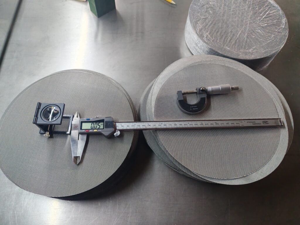 Woven wire mesh discs with a folding magnifier, digital caliper and micrometer