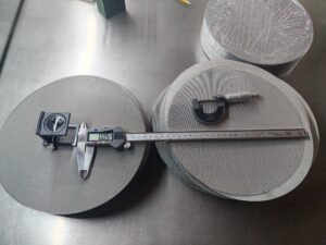 Woven wire mesh discs with a folding magnifier, digital caliper and micrometer